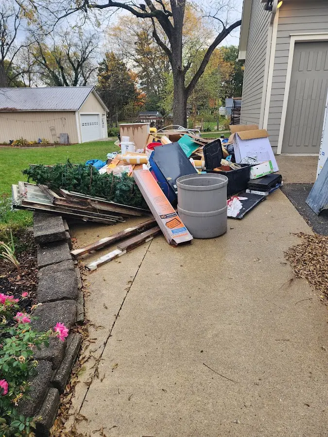 Dumpster being loaded with debris for Estate Cleanout Dumpster Rental in San Martin